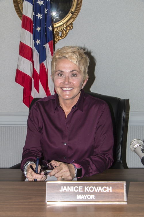 Mayor Janice Kovach sitting at her desk